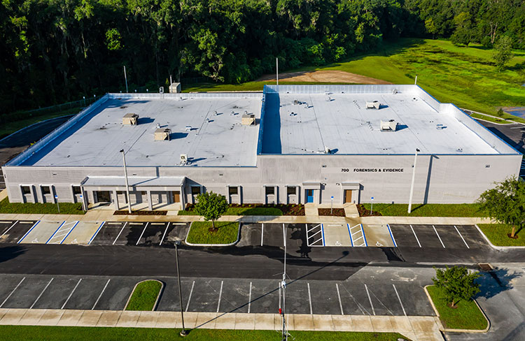 This is an aerial view of the MCSO Evidence bulding in Ocala, FL with a white colored modified bitumen roof. It was a commercial re-roof project. The roofing material installed was modified bitumen. (Commercial Roofing Contractor)