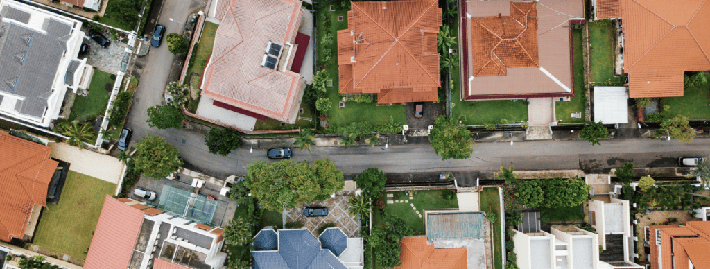 Aerial view of residential roofs with tan and red-colored tile roofs